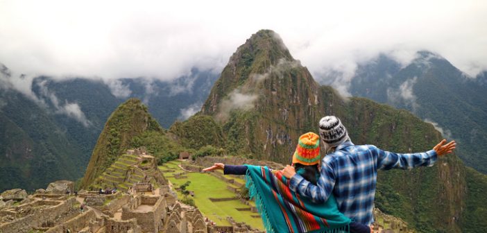 Couple admiring the spectacular view of Machu Picchu